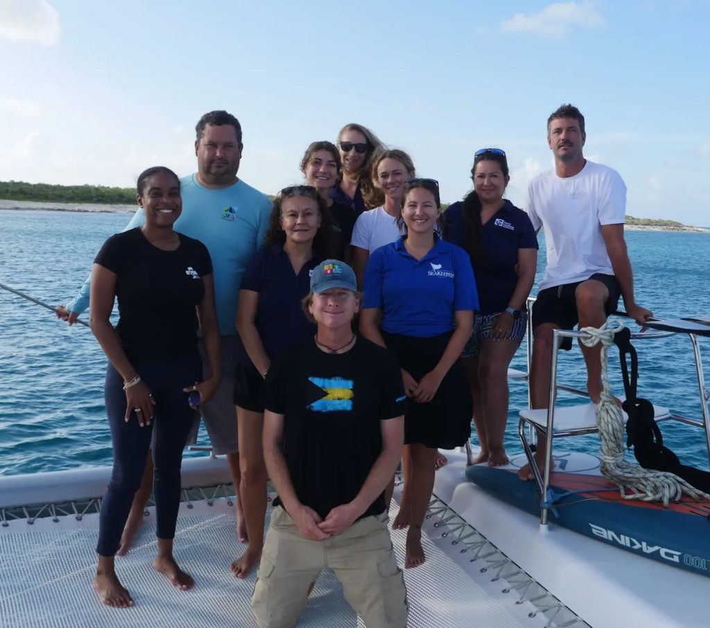 The marine research team and entire crew aboard the expedition vessel, united in their mission to study the vibrant marine life surrounding Little Inagua.