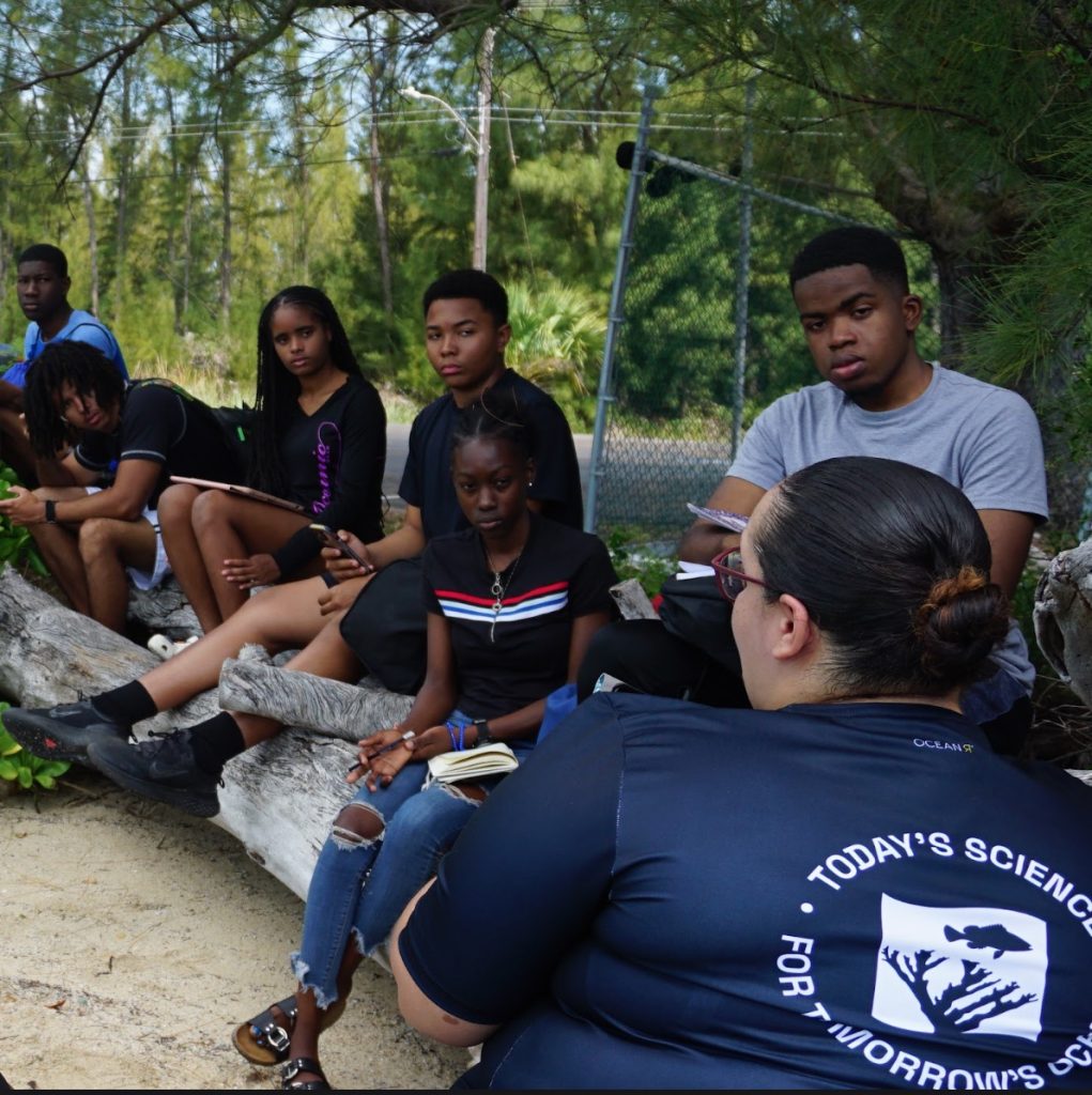 Danielle Cartwright, PIMS Education Coordinator, instructing Rising Tides students outdoors, sharing her knowledge on marine ecosystems and conservation.