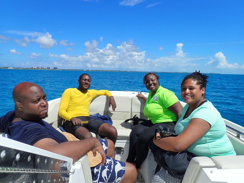 Ready for the Deep Blue: Arnold Hamilton, Herbert Pinder, Laurent Beckman-Miller, and Khadejah Thompson from the Department of Environmental Protection and Planning, beaming with anticipation as they embark on their first ocean dive adventure.